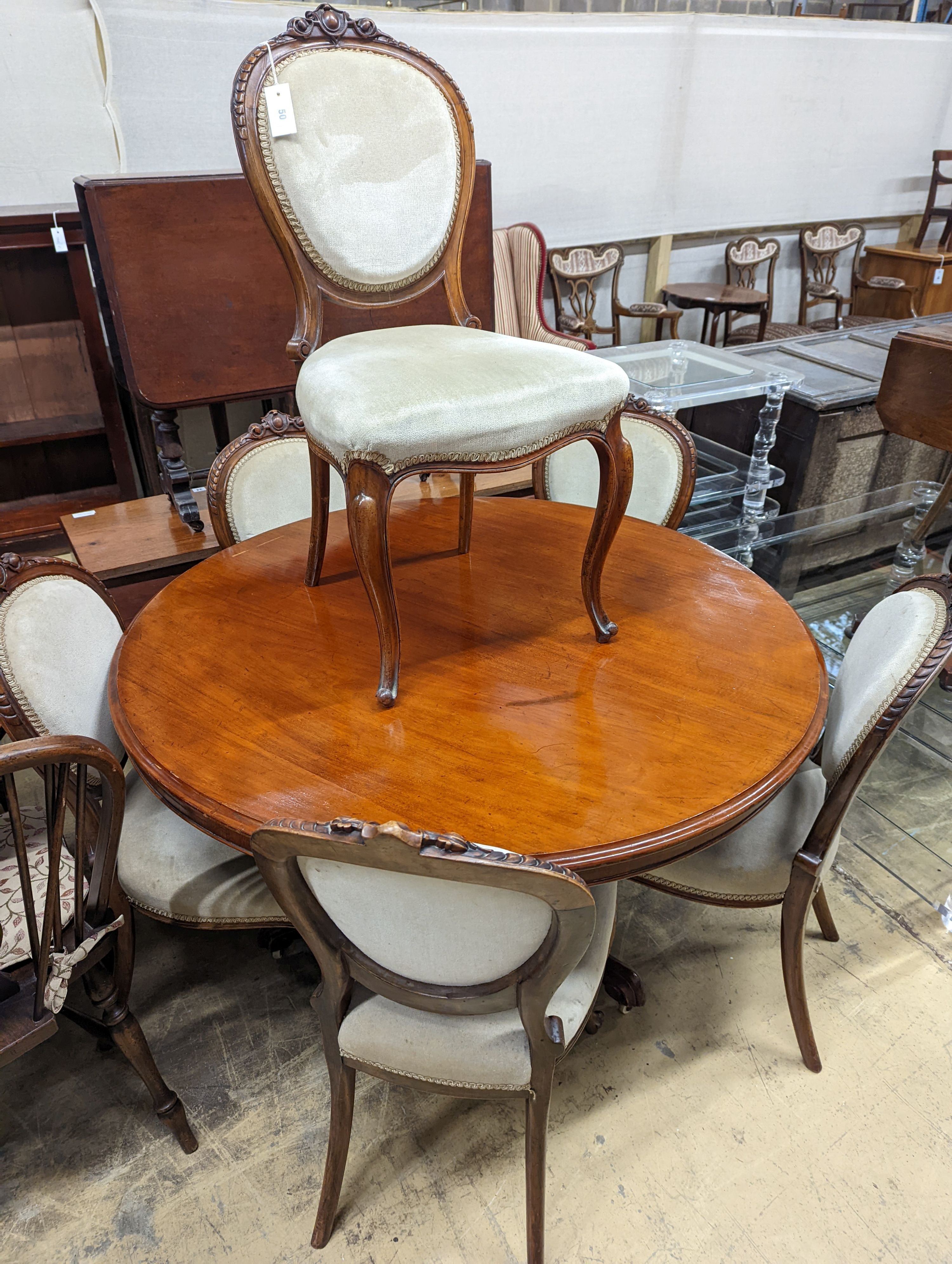 A set of six Victorian mahogany upholstered balloon back dining chairs together with a Victorian mahogany circular breakfast table, diameter 118cm, height 72cm